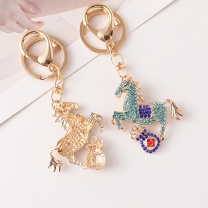 Golden horse keychain with blue crystals and money bag charm for women bags
