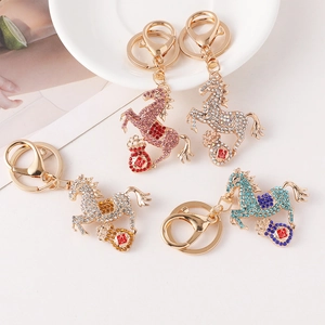 Creative crystal horse keychains in four colors with lucky charms on table
