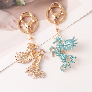 Porte-clés broche licorne dorée avec strass bleu clair pour sacs et vêtements