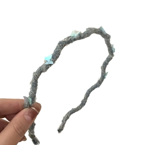 Handmade blue woolen wavy headband featuring delicate translucent butterfly decorations