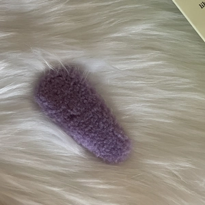 Close-up of soft purple faux fur hair clip with plush teddy fleece texture for women