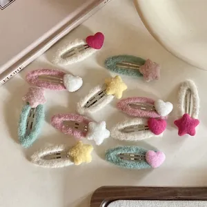 Detail view of knitted heart and star hair clips in pastel colors for girls