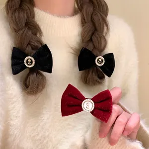 French vintage black velvet bow hair clip with pearl rose accent for elegant styling
