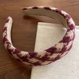 Classic wine red houndstooth thick headband with gold thread on wood surface