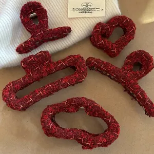 Set of five wine red tweed hair claws in various shapes with golden metallic threads