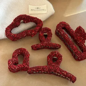 Detailed set of red tweed hair claw clips in heart and geometric shapes for autumn