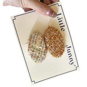 French style tweed and ginger bouclé oval hair clips set on a display card