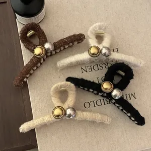 Pinces à cheveux en laine bouclée marron, crème et noire avec des accents métalliques