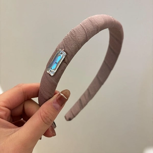 Pink pleated fabric headband with a large rectangular crystal detail for women