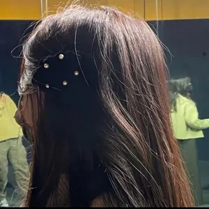 Elegant black velvet hair clip with white pearls in Korean style worn on side hair