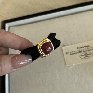 Close-up of French vintage black hair tie featuring a dark red square metallic buckle