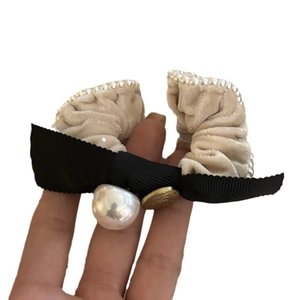 Elegant beige velvet hair scrunchie with black bow, pearls and gold button detail