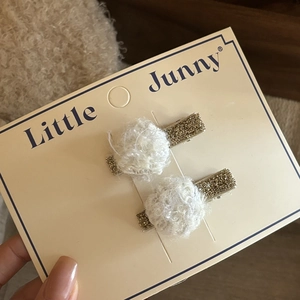 Cute plush white ball hair clips with gold glitter duckbill clips on display card