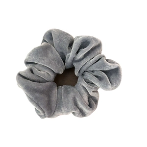 Chouchou en velours bleu poussière de qualité avec texture plissée sur fond blanc