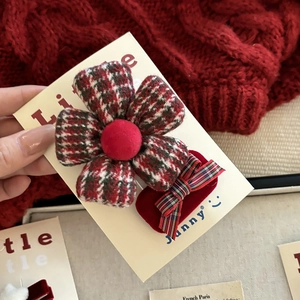 Red and green plaid flower hair clip with festive bow on elegant brand display card