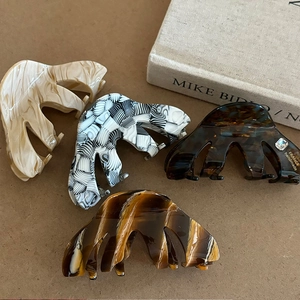 Elegant acetate medium shark clips in marble, checkerboard, and tortoiseshell patterns
