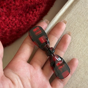 Chic red and black plaid bow hair clip made of glossy resin for autumn fashion style