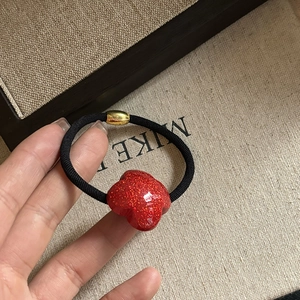 Sparkly red clover charm hair tie on high elastic black band for women's hairstyles
