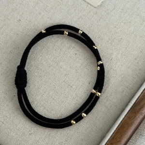 High-elastic double-strand black hair tie featuring eight decorative gold metal beads