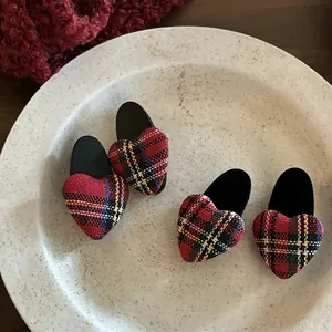 Set of four red plaid heart-shaped hair clips with classic tartan pattern and matte finish