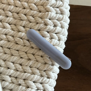Close-up of a minimalist morandi blue resin hair clip with a gold metal duckbill grip