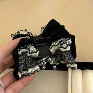 Elegant black velvet bow hair claw clip with delicate lace trim and silver tassel pendant