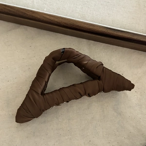Detailed side view of the brown fabric wrapped triangle hair claw clip for thick hair