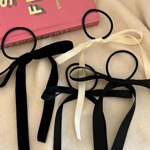 Set of three ballet-style bow ribbon hair scrunchies in velvet and satin finishes