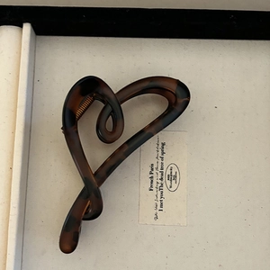 Elegant heart-shaped tortoiseshell acetate hair claw clip with a secure metal spring