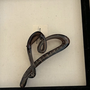 Macro shot of tortoiseshell patterned heart hair claw clip with glossy finish