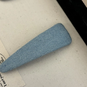 Light blue denim fabric wrapped duckbill hair clip with diagonal cotton texture