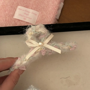 Macro shot of fluffy multicolor plush hair claw clip with bow and pearl embellishment
