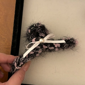 Elegant plush bow hair claw clip with faux pearl detail and black pink faux fur texture