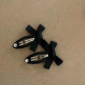 Elegant pair of black satin bow hair clips with sparkling floral rhinestone accents