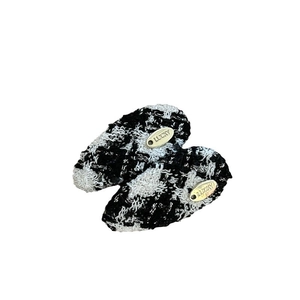 Elegant pair of black and white woven hair clips featuring gold Lucky metal charms