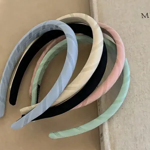 Set of pastel fabric headbands in assorted colors with twill texture and handmade label