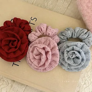Three-piece set of elegant rose-shaped hair scrunchies in red, pink, and blue colors