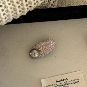 French vintage light blue tweed hair clip with a large grey pearl and gold brand tag