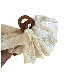 French lace claw clip in amber brown featuring white embroidered wavy ruffles