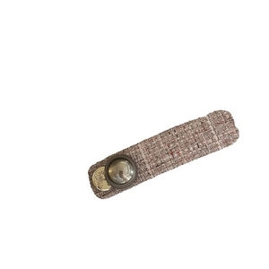 Elegant tweed barrette in pink and beige with a round gold pendant and mirror bead detail