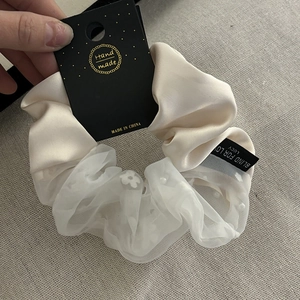 Elegant cream satin and organza scrunchie with floral patterns and pearl detail