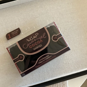Detailed view of 10 brown elastic hair ties in a transparent retail gift box