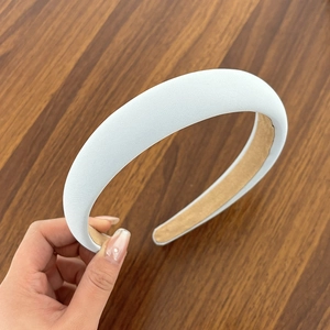 Padded light blue sponge headband with thick fabric covering for volume hairstyles