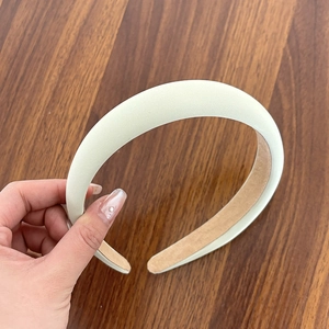 Detailed close-up of cream-colored padded sponge headband with soft non-slip velvet lining