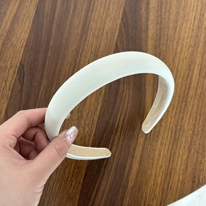 Detail of padded cream headband with anti-slip inner lining and matte finish