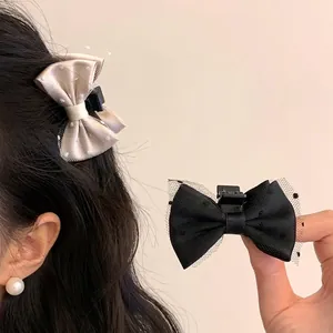 Elegant black and beige mesh bow hair clips with polka dot lace for women's hairstyle