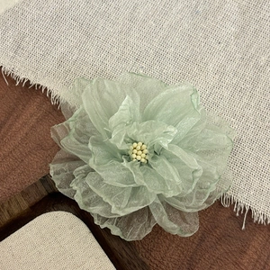 Elegant light green fabric flower hair clip with textured petals for spring fashion