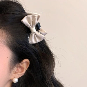 Elegant champagne satin and polka dot mesh bow hair clip for a retro princess style look