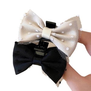 Set of black and cream mesh bow hair claws featuring elegant polka dots and fabric texture