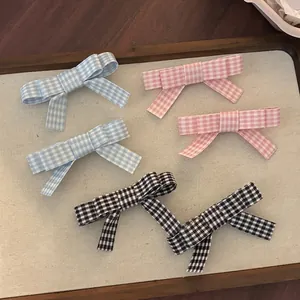 Sweet plaid bow hair clips in blue, pink, and black-white checkered patterns for women